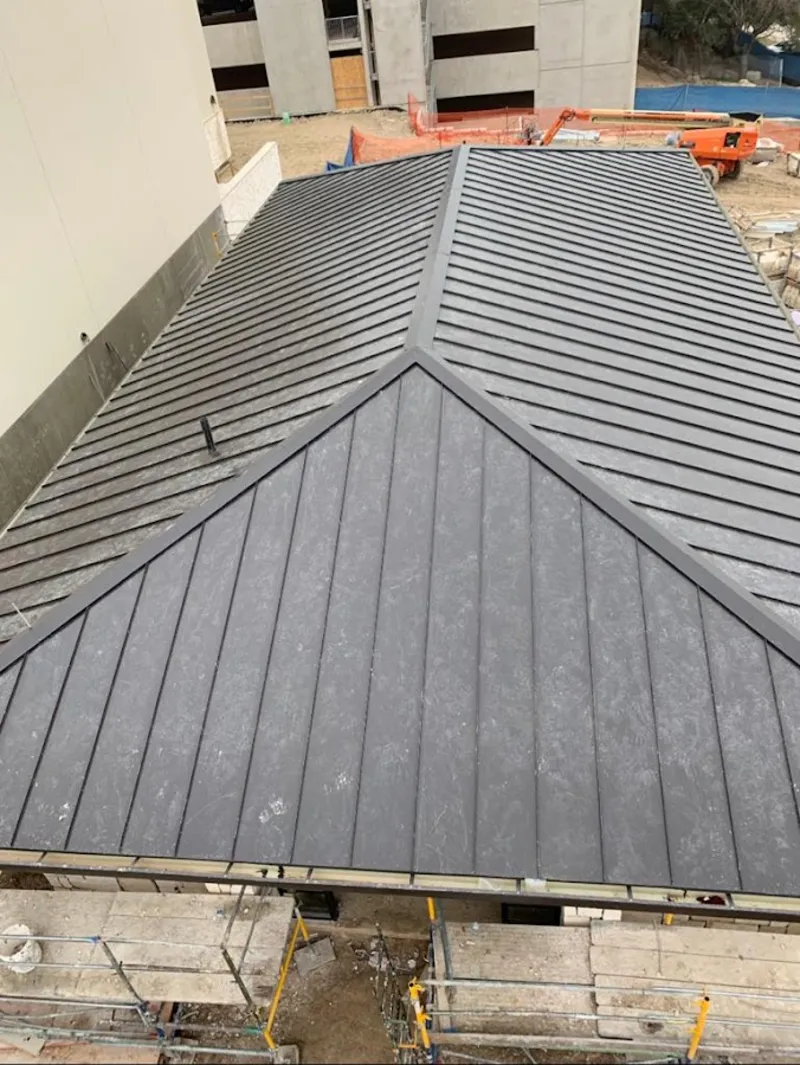 Commercial metal roof construction with crane equipment in Knoxville
