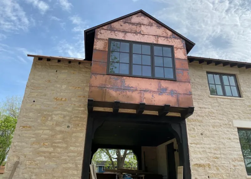 Copper metal panel facade on a stone building for Roof Repair in Knoxville